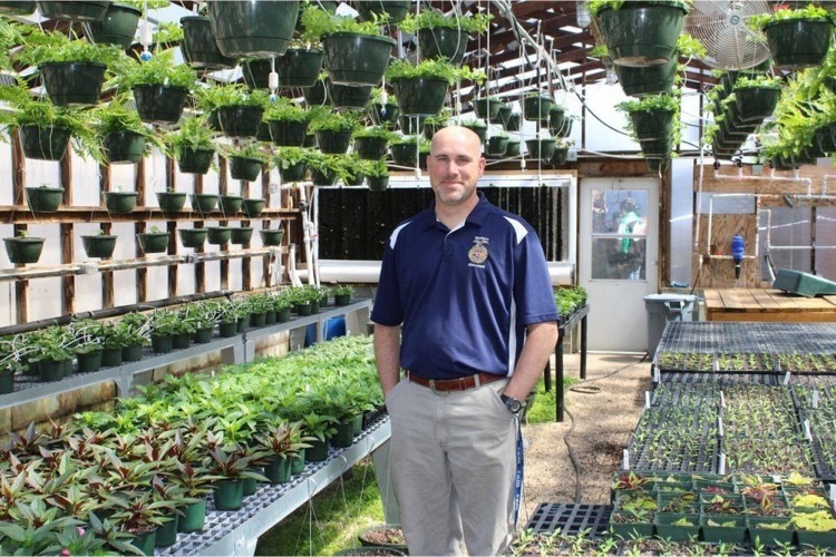 Photo of Joe Miciotto in greenhouse 