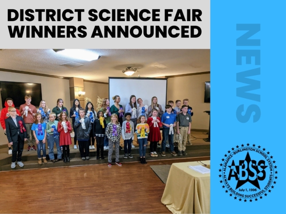 Photograph of the district science fair elementary, middle, and high school winners .  Above is black text "DISTRICT SCIENCE FAIR WINNERS ANNOUNCED" and on the right on a blue bar, grey text "NEWS" with black ABSS logo.