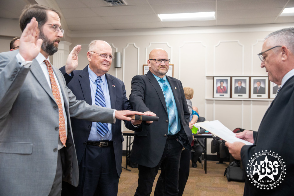 Dr. Charles Parker, Dan Ingle, and Chuck Marsh being sworn in at ABSS Board of Education meeting 