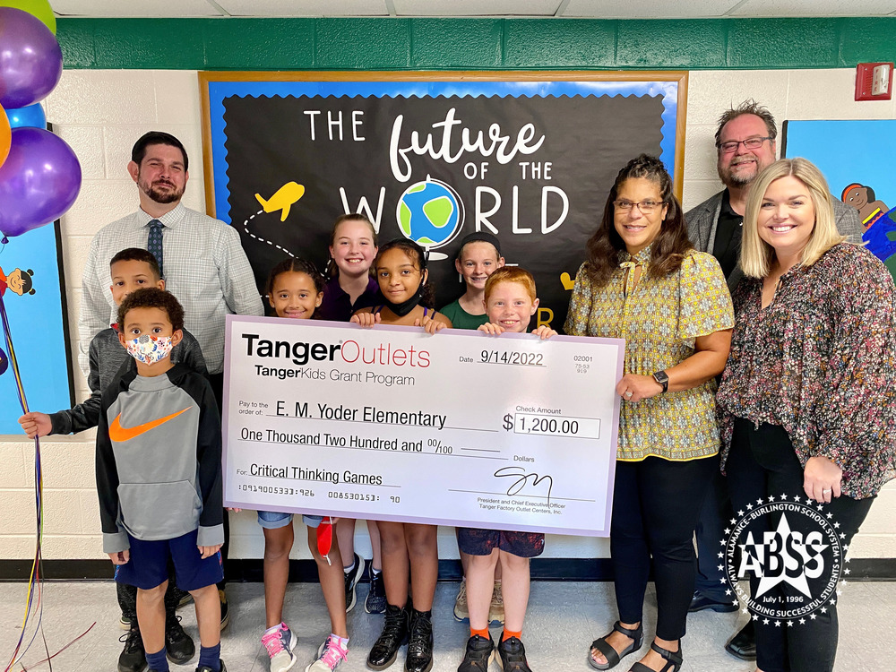 Teacher and students at EM Yoder Elementary holding Tanger grant check