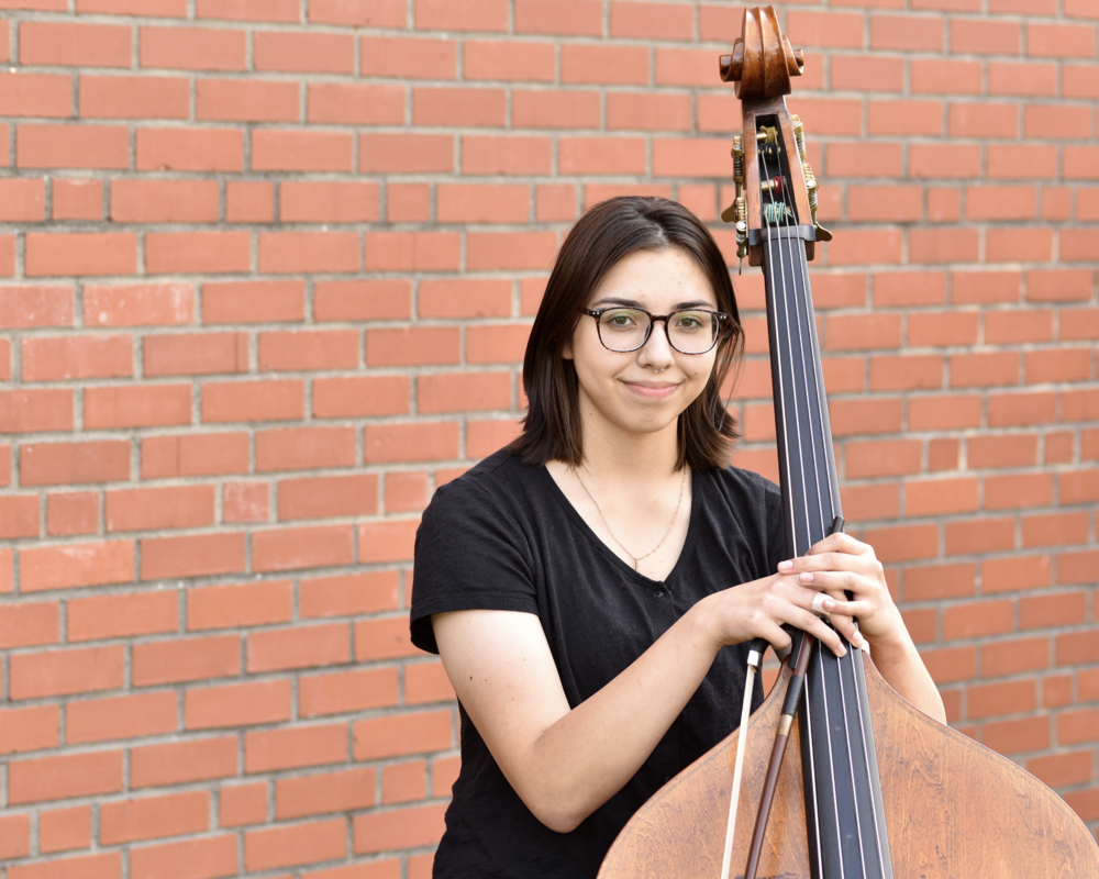 Williams High School Senior Carol Alvarado posing with her bass