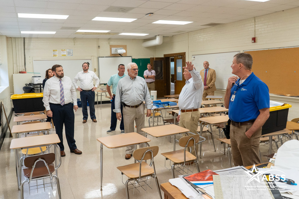 Superintendent Dr. Butler, ABSS Board of Education members, County Commissioners, Deputy Superintendent Lowell Rogers, Chief Operations Director Greg Hook examine mold in a classroom