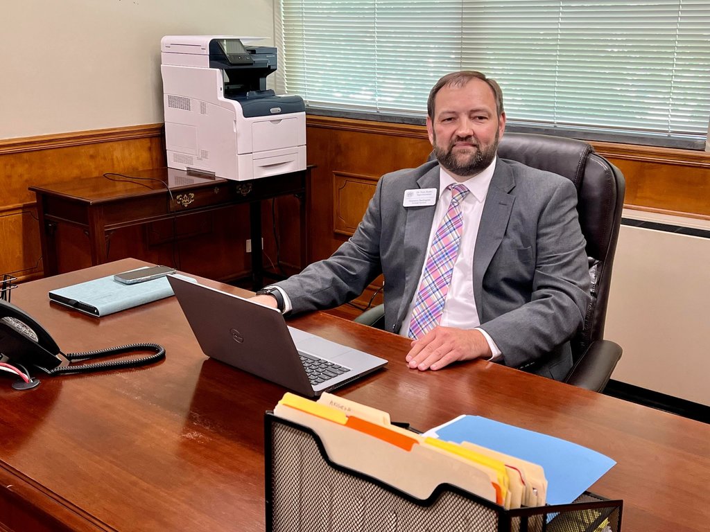New Superintendent Dr. Butler sitting at his desk on day 1 of his new role.