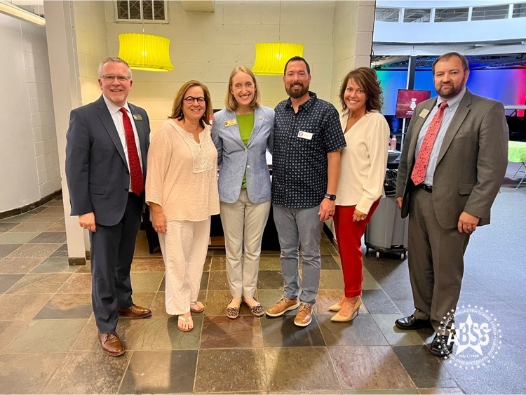 former teachers of the year Christopher Doi and Kelly Poquette pose for a photo with ABSS board members and ABSS administrators at the education council meeting
