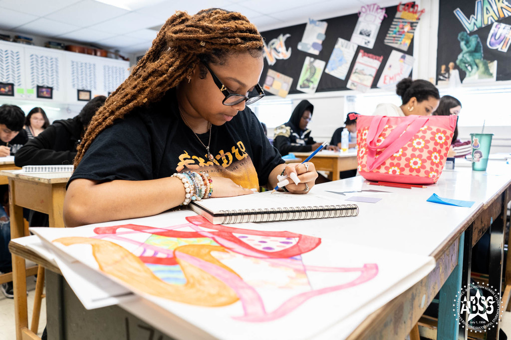 Student in art class drawing at Williams High 