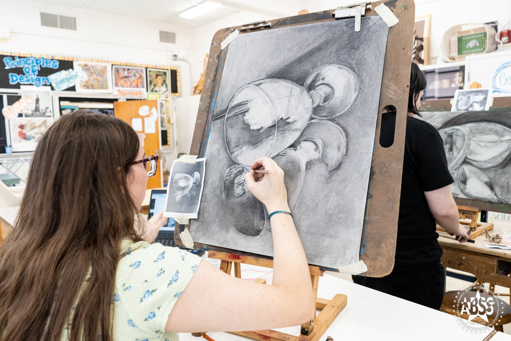 Student in art class drawing at Williams High 