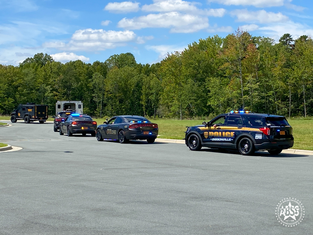 First responders drive past Elon Elementary as part of the First Responders Parade