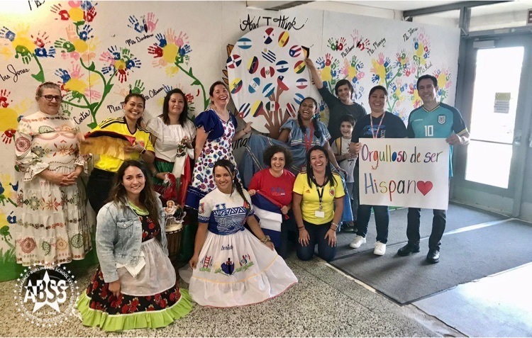 group of teachers wearing clothes from their native countries to celebrate global studies  