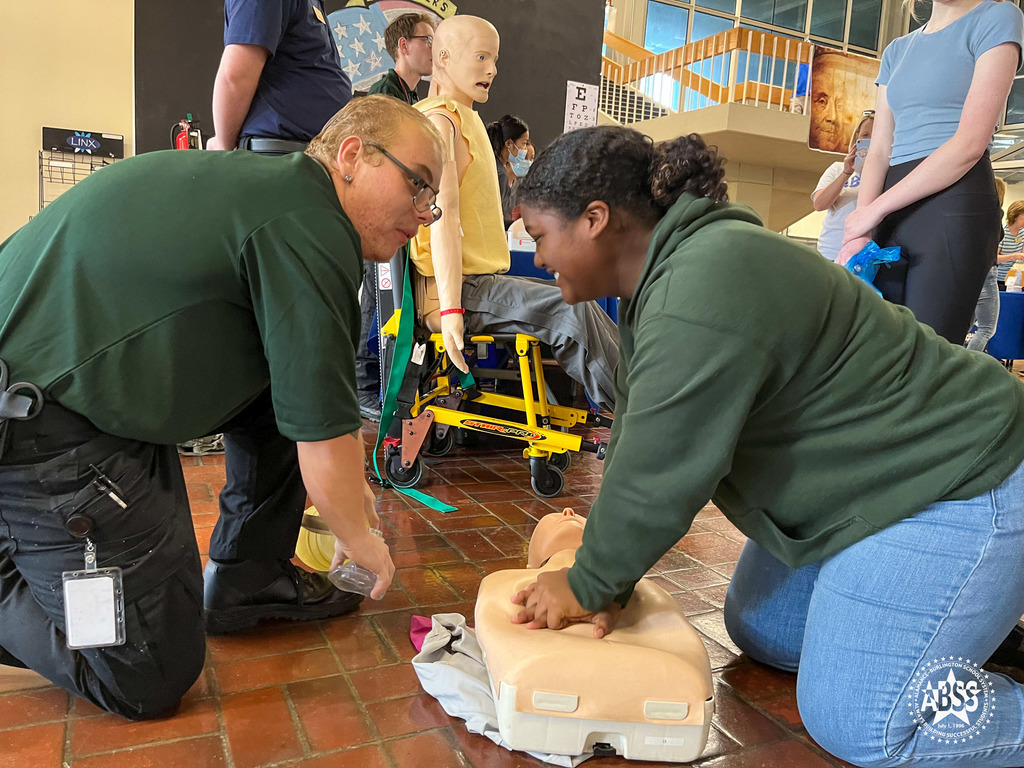Alamance Burlington Early College students performing CPR on a dummy at Alamance Community College