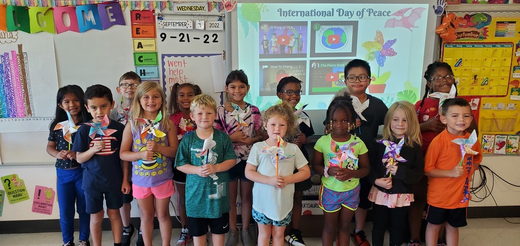 Students holding pinwheels they created as part of International Day of Peace 
