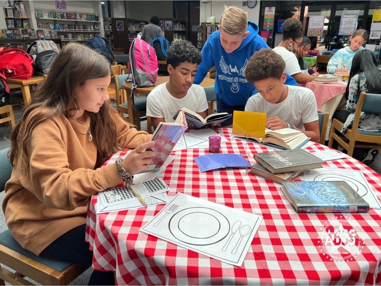 students reading books as part of a book tasting exercise at Western Middle  