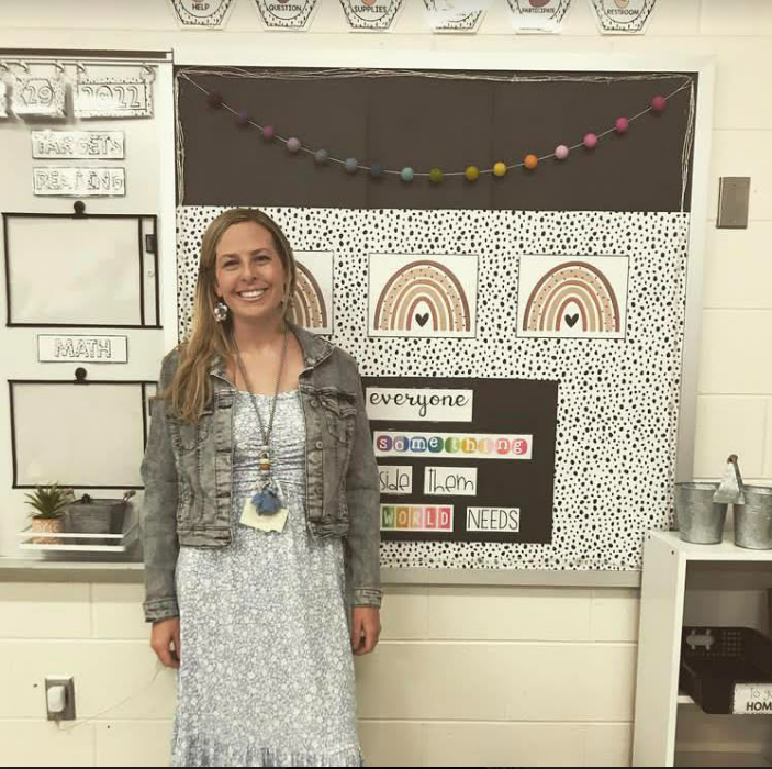 Lisa Rambeaut standing in front of a display board in her classroom