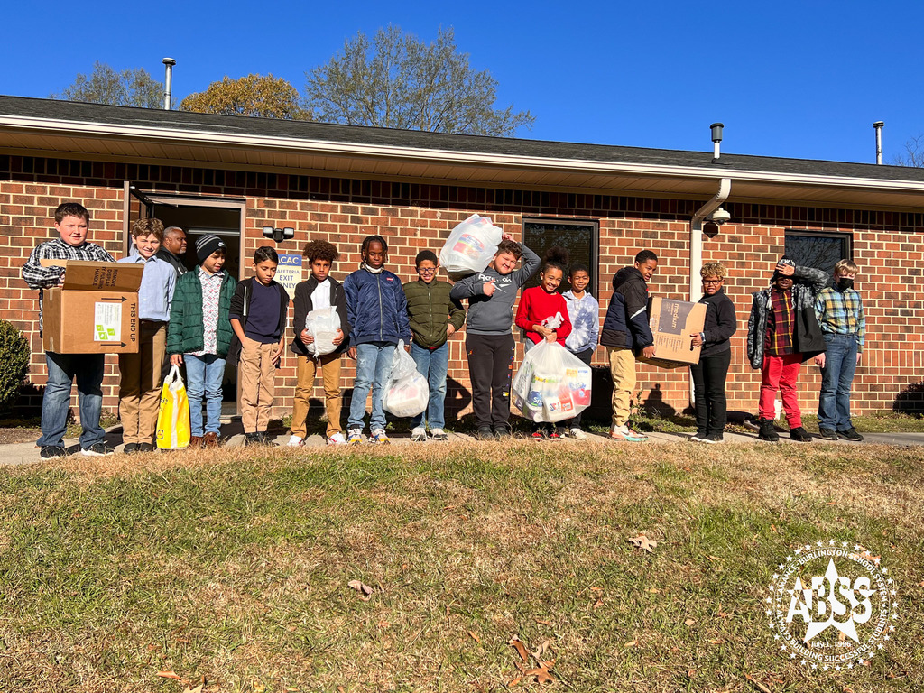 The Responsible Respectful Boys Group of Pleasant Grove standing in front of a homeless shelter holding various paper goods they are donating.