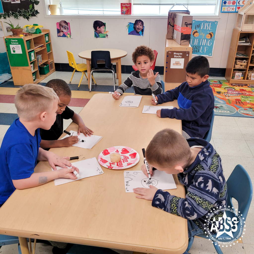 Five pre-kindergarten students sit around a table and draw their observation of a frozen snack melting on a paper plate