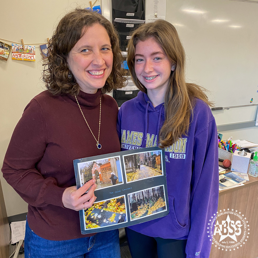 Sophomore Meredith Doi from Early College standing with her mom Courtney and a photograph of her grandmother visited a family graveyard in Germany.  This was part of a presentation about Meredith's great-grandmother who survived the holocaust.