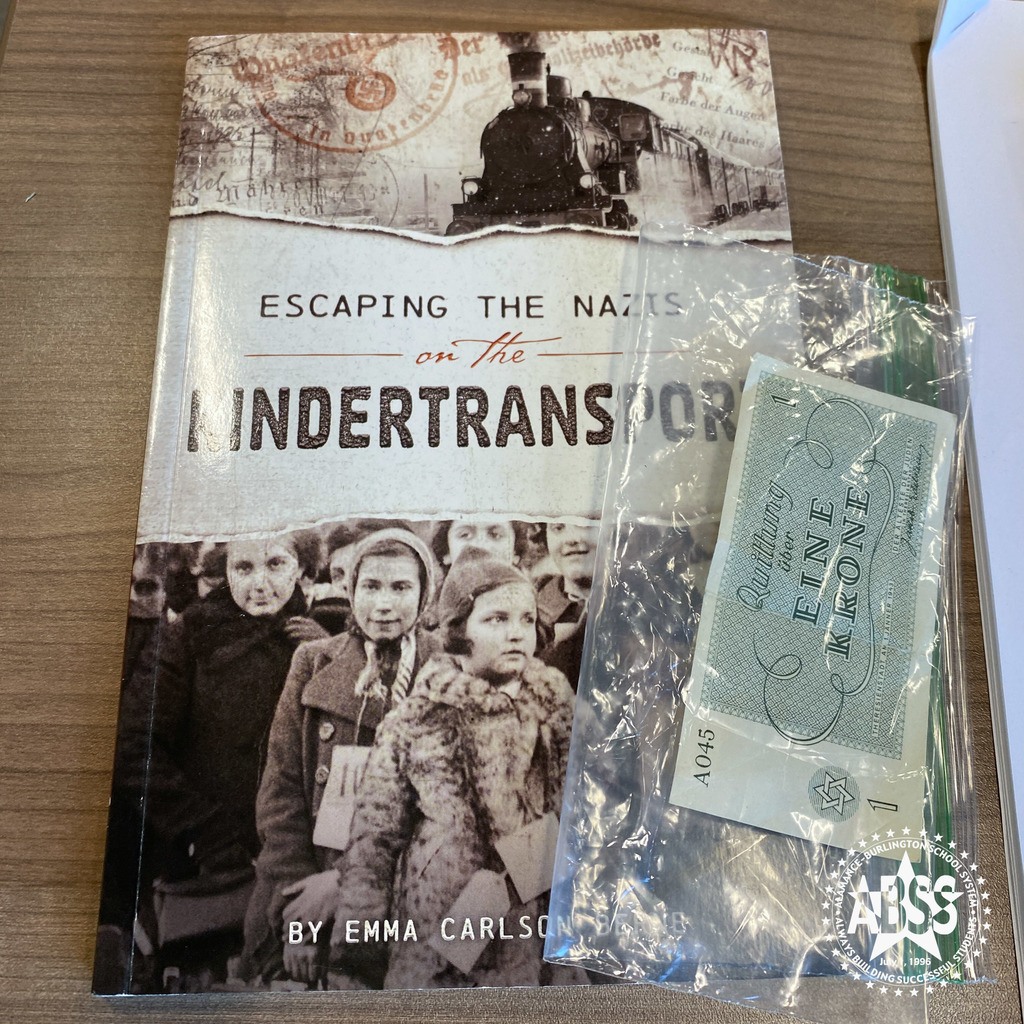 Photograph of the book Escaping the Nazis on the Kindertransport and some money used in a concentration camp to boost. morale