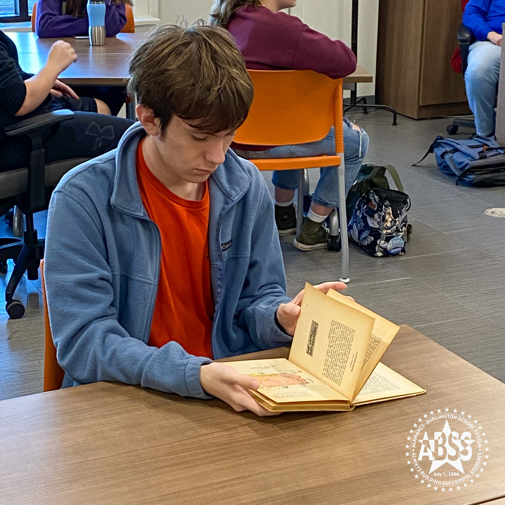 A student from the English 2 class at Early College looks through an old Jewish children's book from World War II