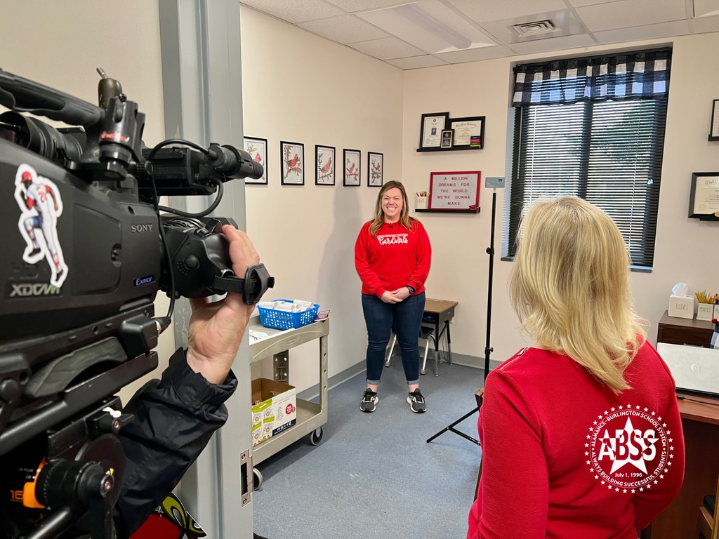 A teacher at North Graham Elementary stands in front of a camera and Fox 8's Cindy Farmer during an interview