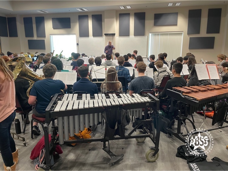 students practicing music in a band room.  