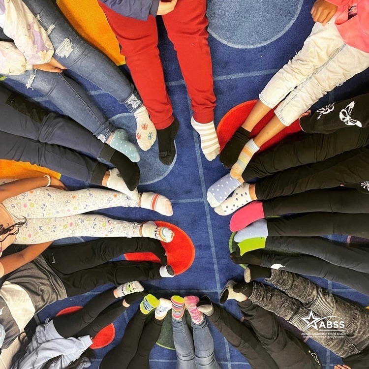 photo of students wearing different colored socks for world Down syndrome day 