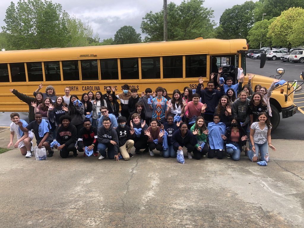 Rising 9th Graders visiting the Early College at Alamance Community College pose in front of a school bus