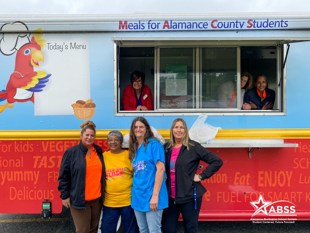 Nutrition staff and AO Elementary staff pose in and around the MAC'S Diner food truck