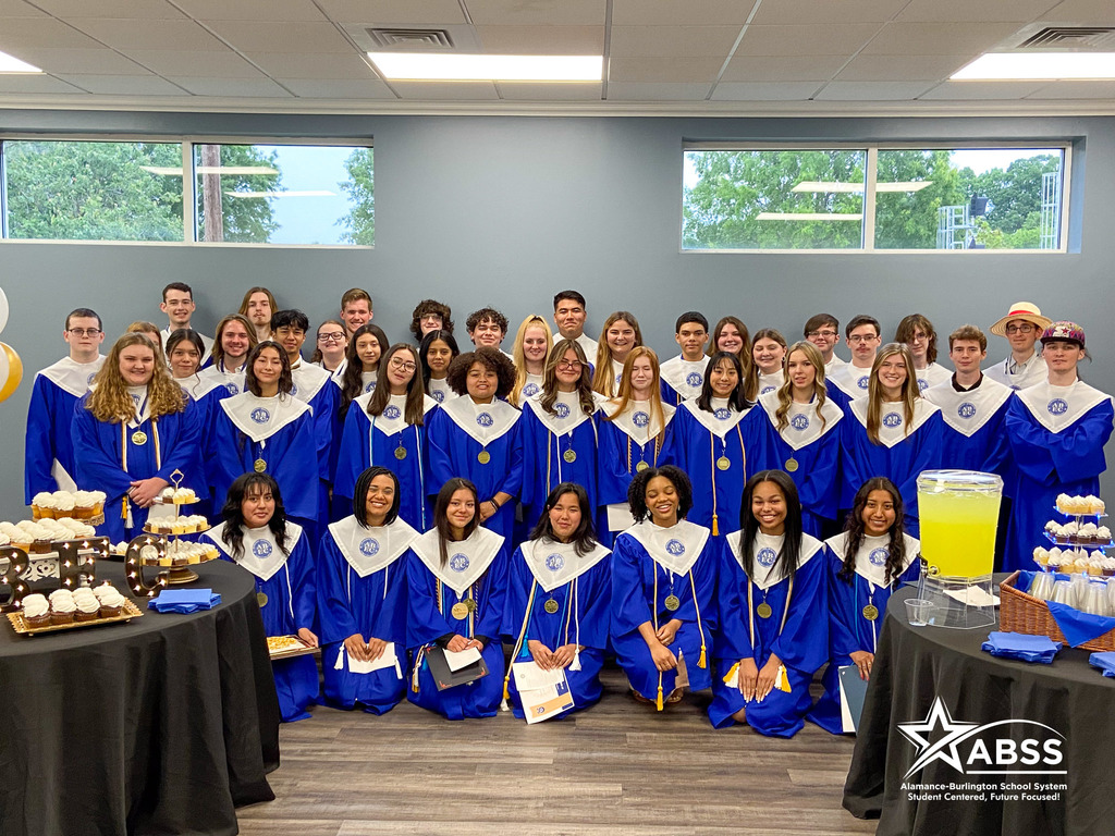 Group photograph of seniors wearing robes and regalia at the Early College senior awards night