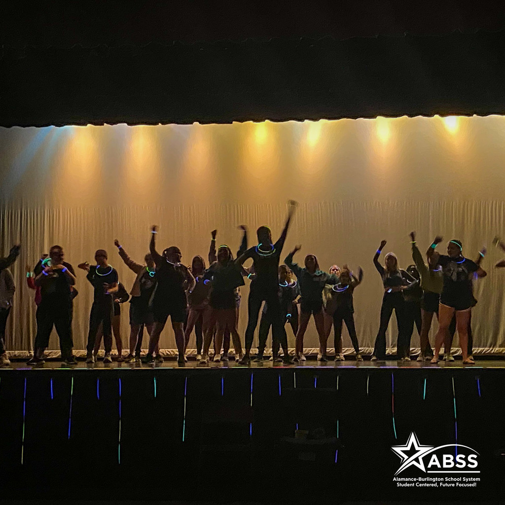 National Honor Society of Dance Arts of Southern Alamance High School performs on stage in the dark and wearing glowing accessories