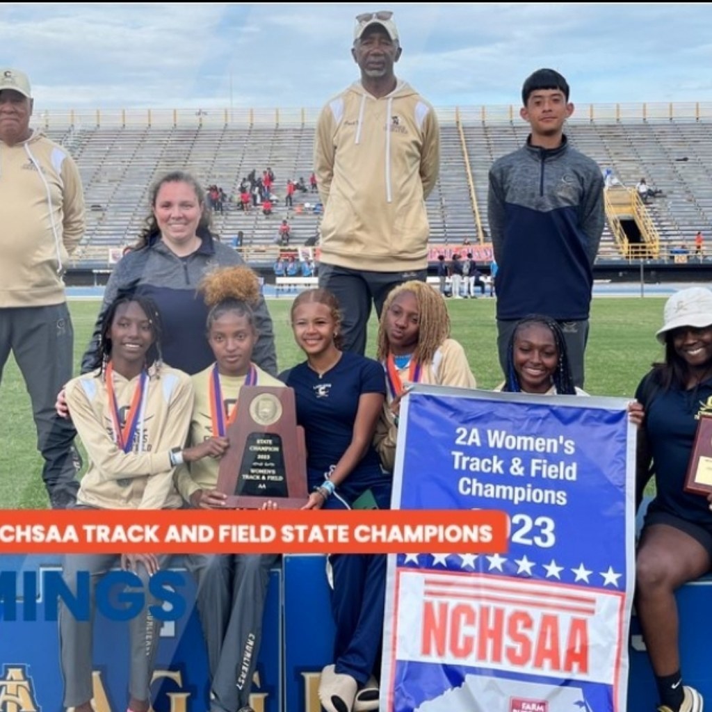 The Cummings High School women's track and field team posing with the accolades at the NCHSAA 2A Women's Track and Field Championship