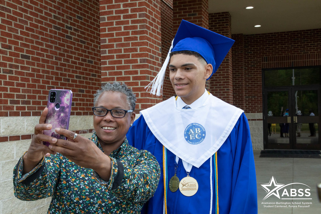 ABEC graduate posing with family member for selfie