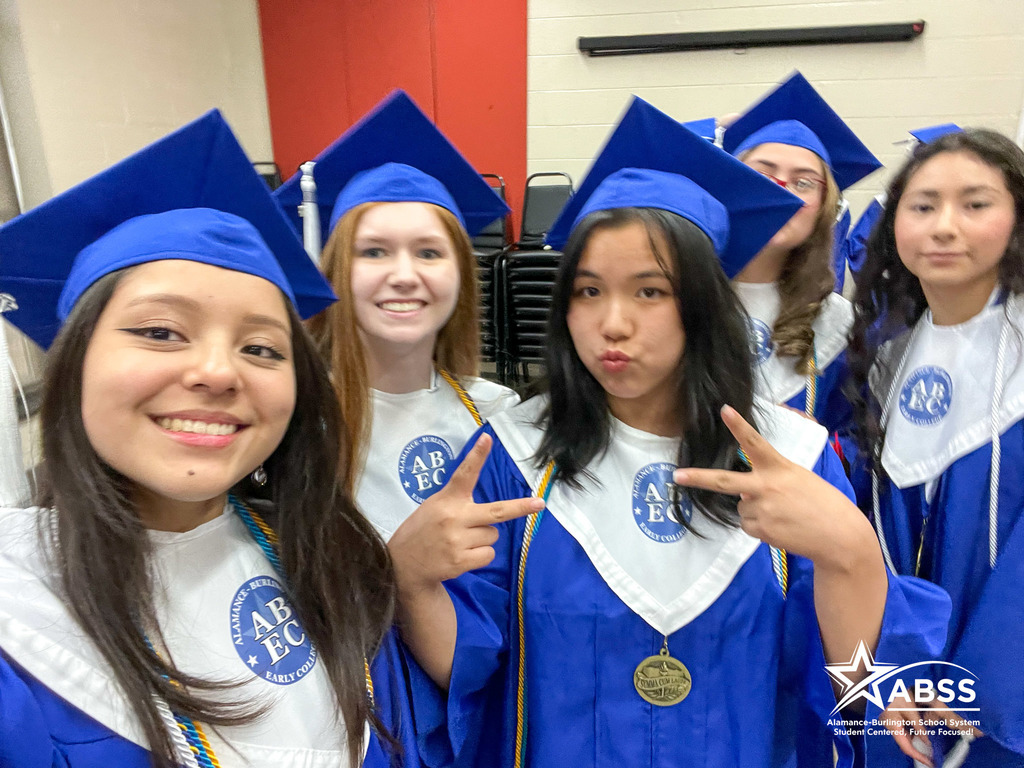 Seniors from the Early College at ACC posing for a selfie in their blue cap and gowns