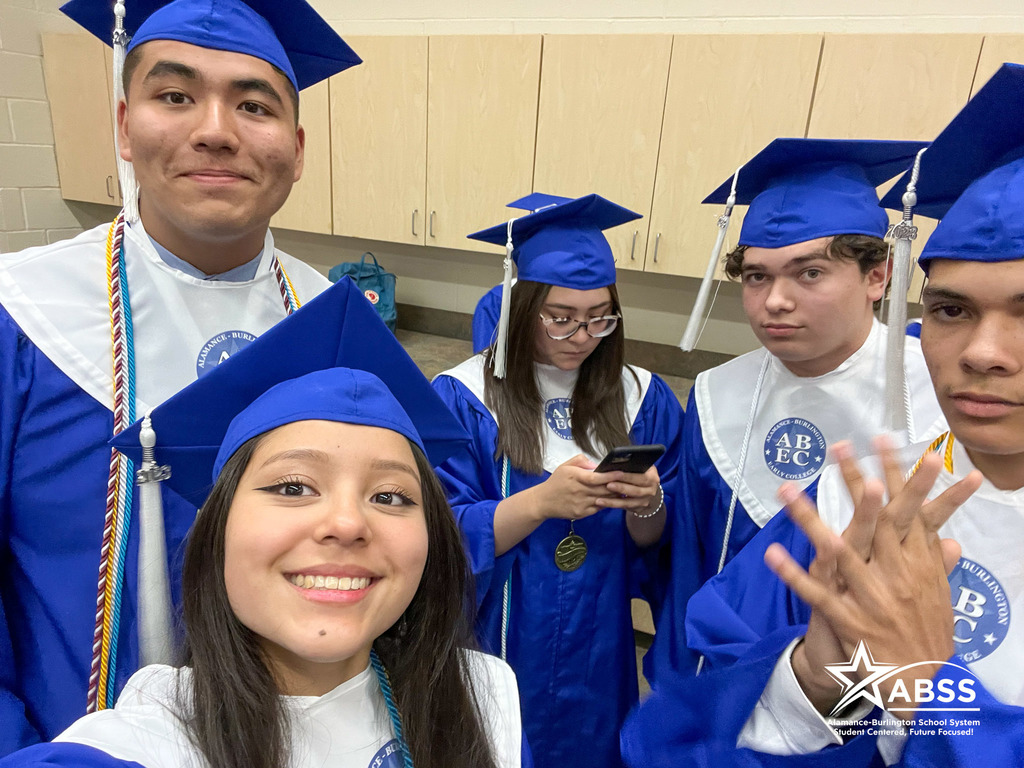 Seniors from the Early College at ACC posing for a selfie in their blue cap and gowns
