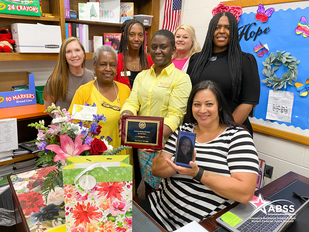 ABSS Social worker, nurse, and counselor leaders posing for a group photograph in the office of school social worker of the year Brittany Myers