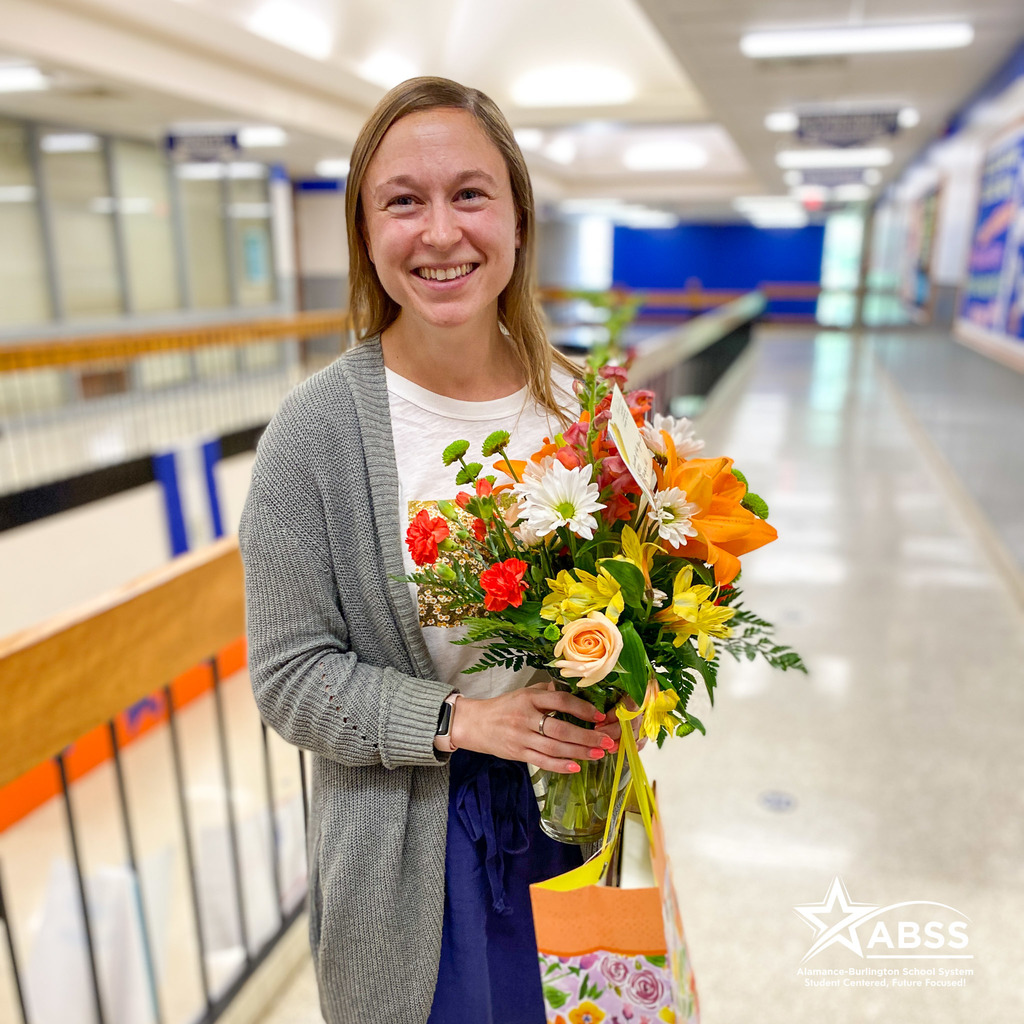 ABSS Counselor of the Year Anne Goldberg poses with a bouquet of flowers and a gift bag