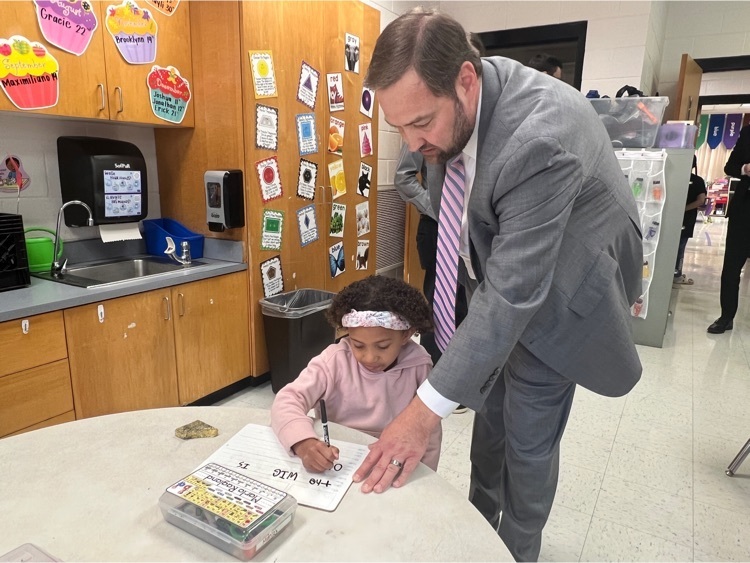 Dr Butler helping child in classroom 