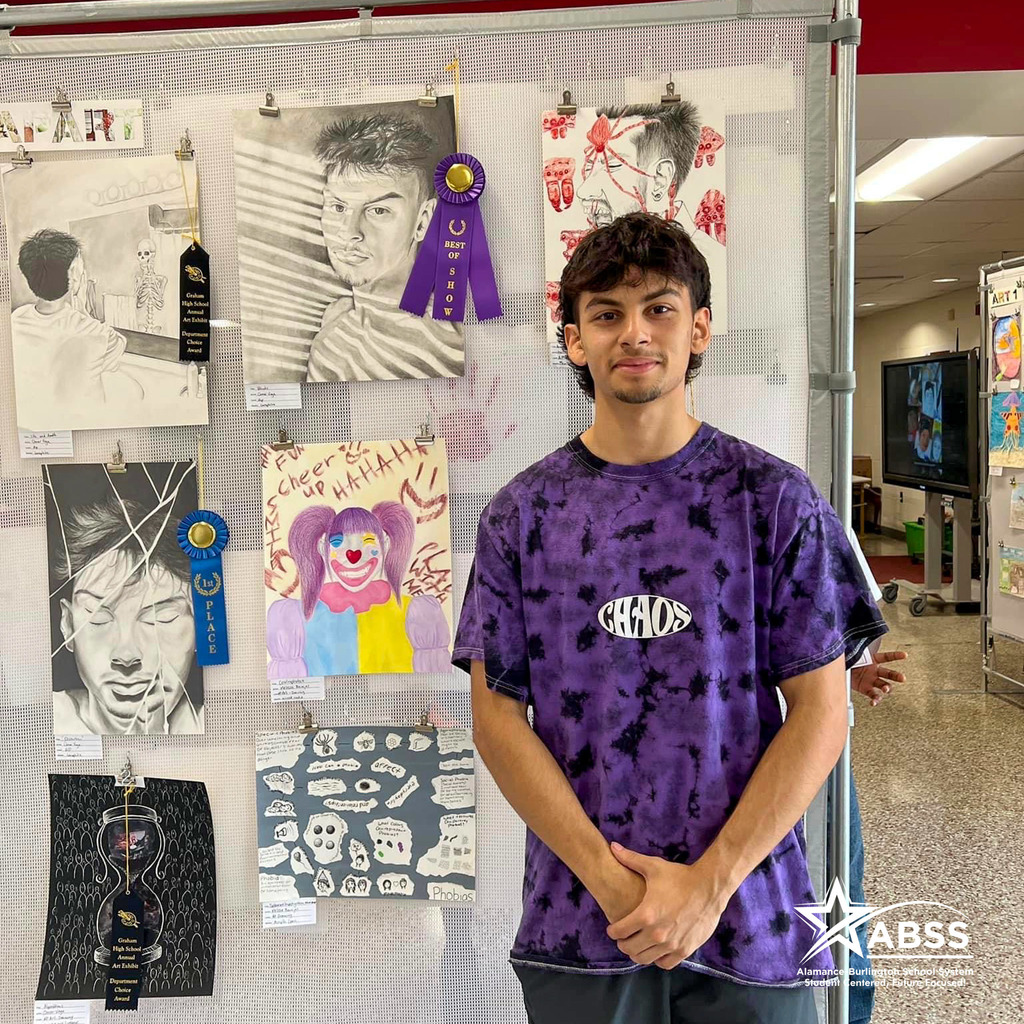 Graham High School student Omar Vega standing beside his best of show winning drawing
