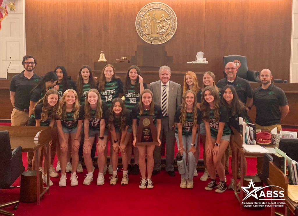 Photograph of the Eastern Alamance girls soccer team standing with House Representative Steven Ross in the General Assembly in Raleigh