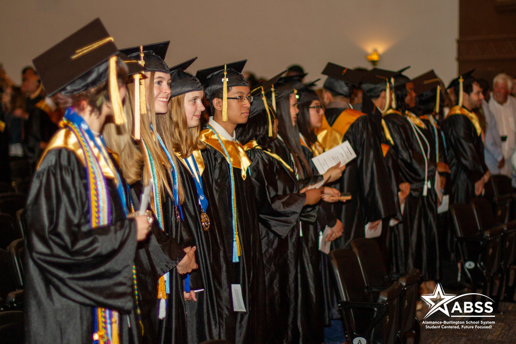 A line of graduates look toward the stage at Williams High School