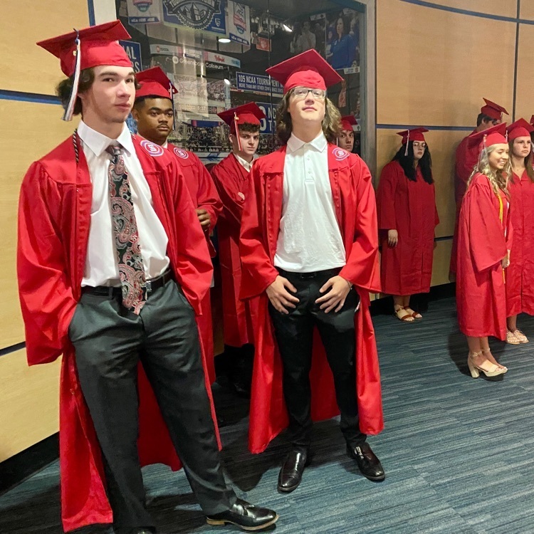 Southern HS seniors standing in robes waiting for the ceremony to begin