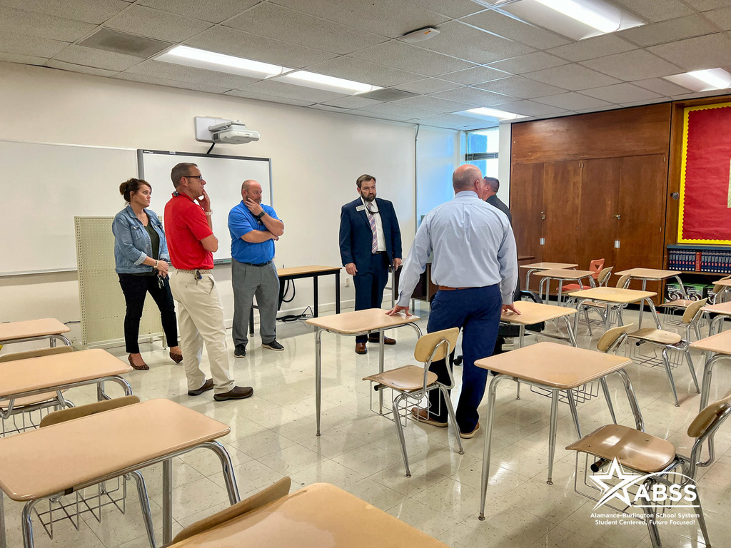 ABSS Board Members and Builder Services personnel discuss cleaning progress in a classroom at Cummings High School