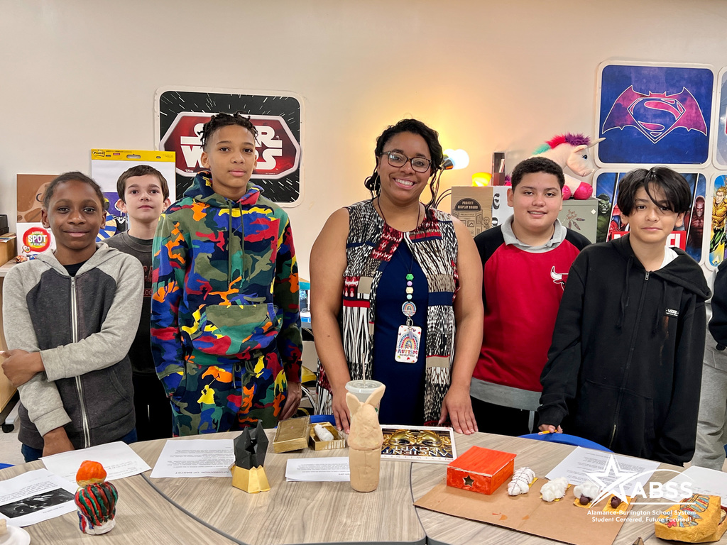 Teacher Chanel Jones with students at Broadview Middle School standing behind their "artifacts" created for an ancient Egypt class museum