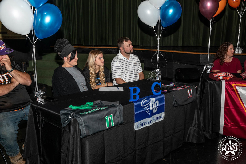 Aryanna Parker - Brevard College - Softball with her family at table with Brevard banner draped over black table cloth