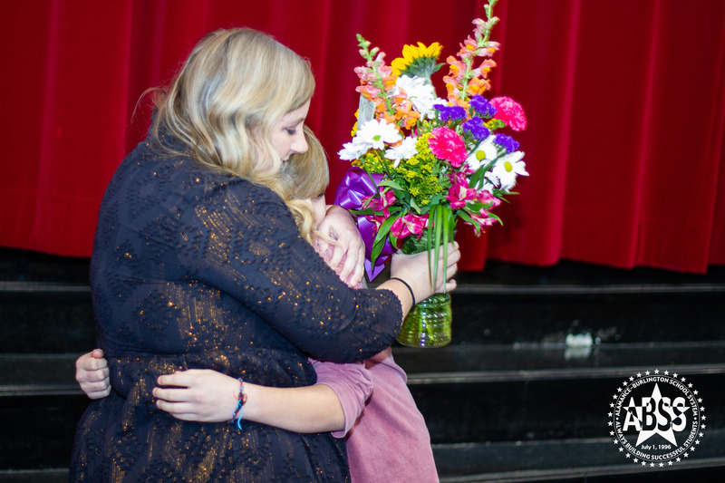 Meredith Draughn receiving flowers from student 