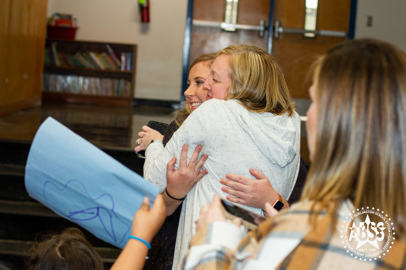 Meredith Draughn bring hugged by staff member