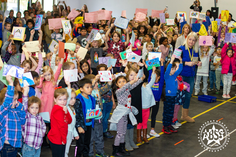 Students holding signs to celebrate Meredith Draughn being named National School Counselor 