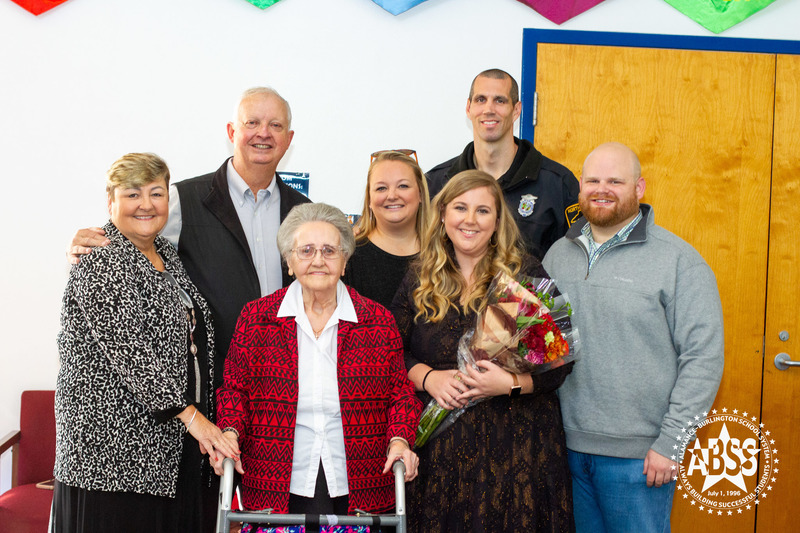 Meredith Draughn with her family posing with flowers 