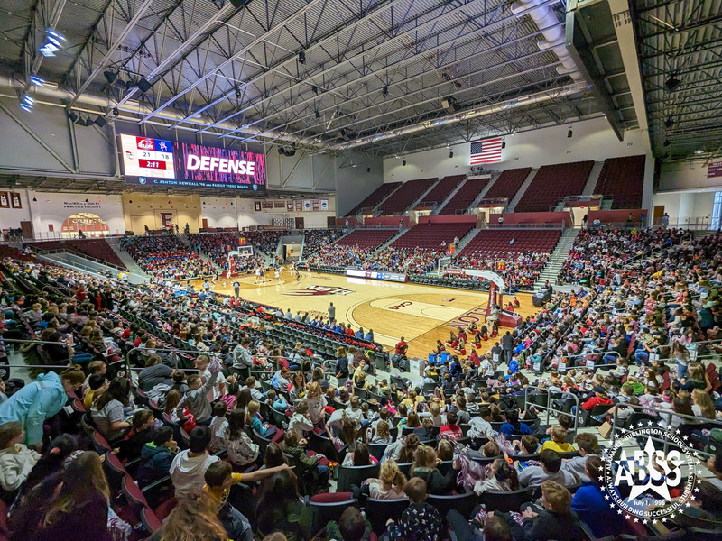 A wide angle shot of the Schar Center with seats filled with elementary students during Education Day