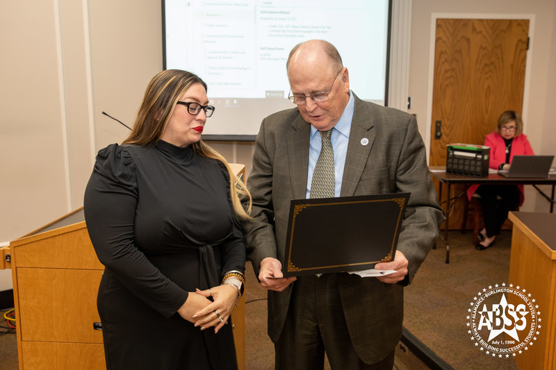 Lindsey Criss receiving certificate by Dan Ingle at Board Meeting