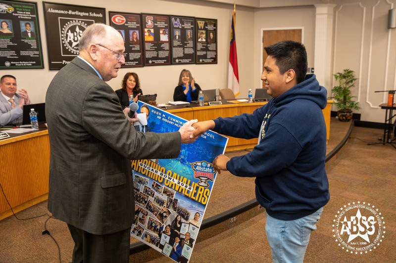 Band President Cesar JuanPedro presents Dan Ingle with Signed Poster by band 