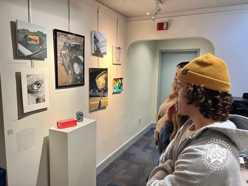 People looking at artwork in gallery at Paramount Theater